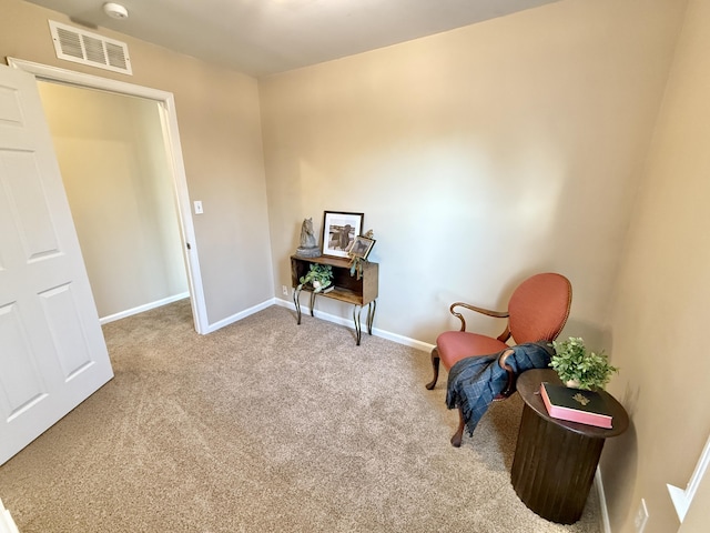 sitting room with visible vents, baseboards, and carpet