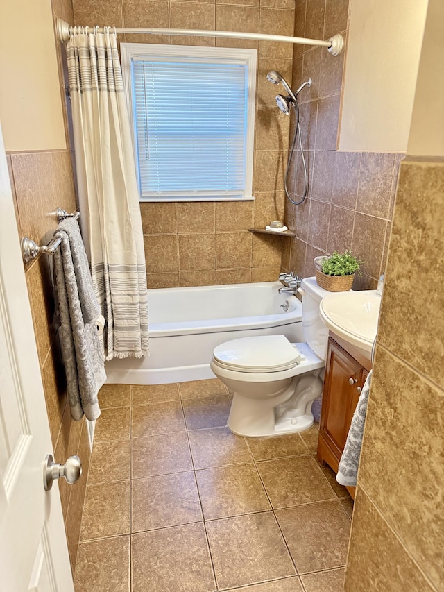 full bathroom featuring toilet, vanity, shower / bath combo, tile patterned floors, and tile walls