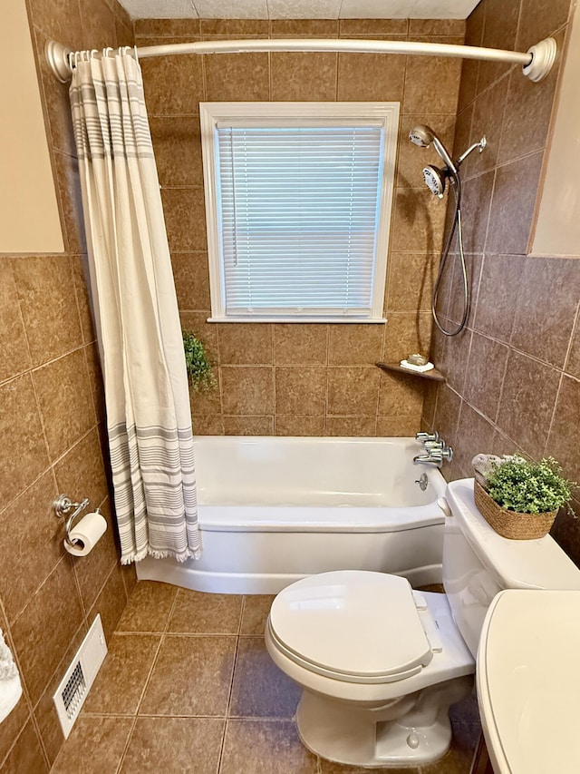 full bath featuring visible vents, toilet, shower / tub combo with curtain, tile walls, and tile patterned flooring