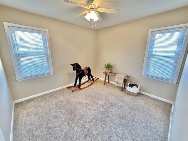 unfurnished room featuring baseboards, carpet floors, and a ceiling fan