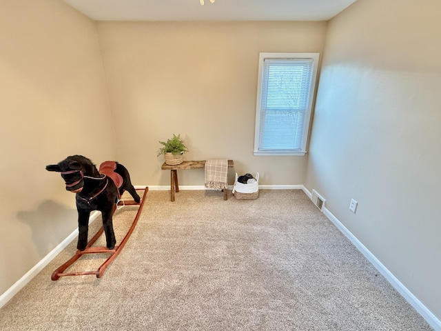 living area featuring visible vents, baseboards, and carpet floors