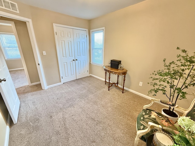 miscellaneous room with visible vents, baseboards, and carpet