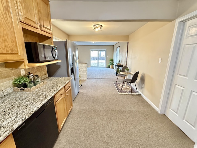 kitchen with baseboards, light stone countertops, light colored carpet, decorative backsplash, and black appliances