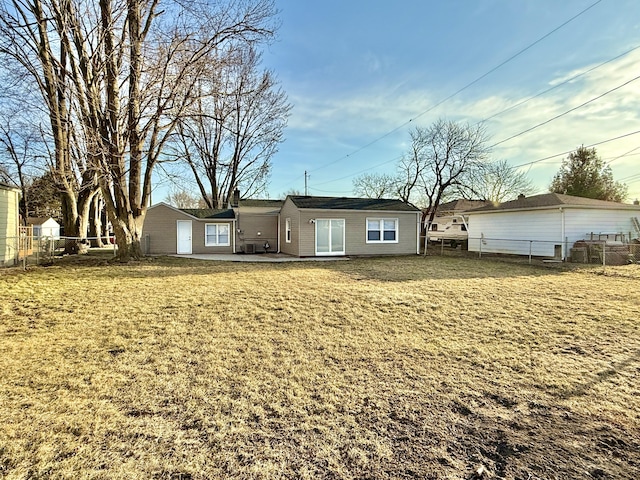 rear view of property with a yard, a patio area, and fence