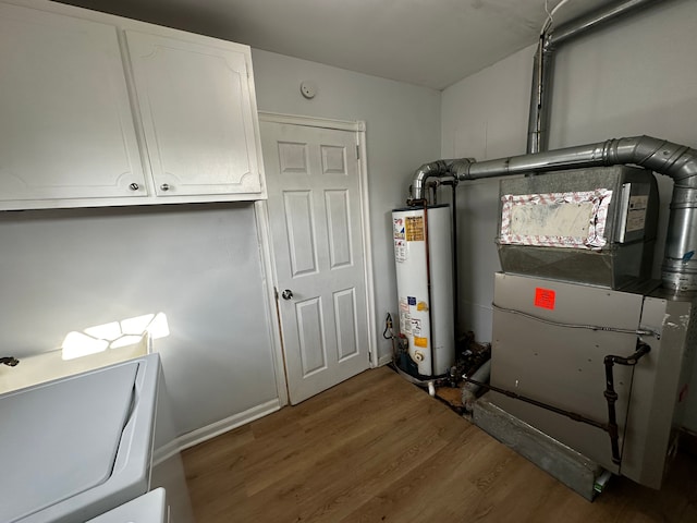 utility room featuring gas water heater, heating unit, and washer / clothes dryer