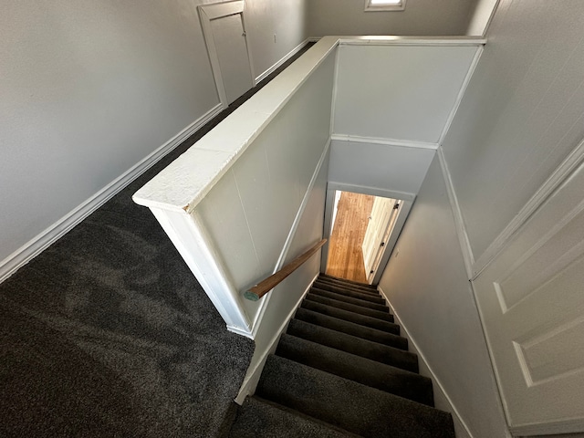 stairway with carpet flooring and baseboards