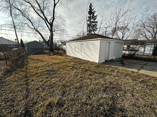 view of yard featuring an outdoor structure and fence