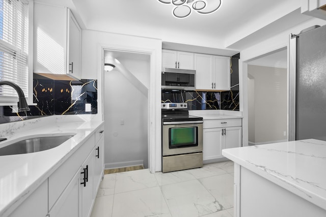 kitchen featuring decorative backsplash, appliances with stainless steel finishes, marble finish floor, white cabinetry, and a sink