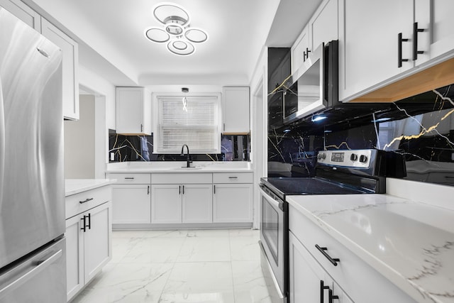 kitchen with a sink, white cabinets, marble finish floor, and stainless steel appliances