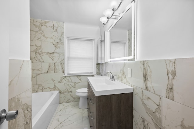 bathroom with toilet, marble finish floor, a bathing tub, tile walls, and vanity