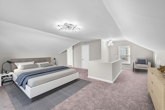 bedroom with baseboards, lofted ceiling, and carpet