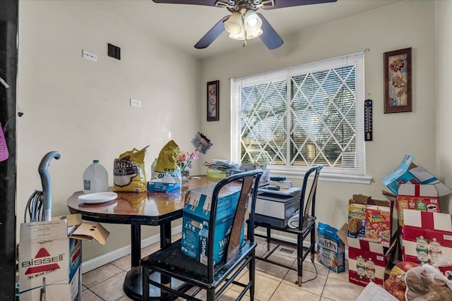 dining room with tile patterned flooring, baseboards, and ceiling fan