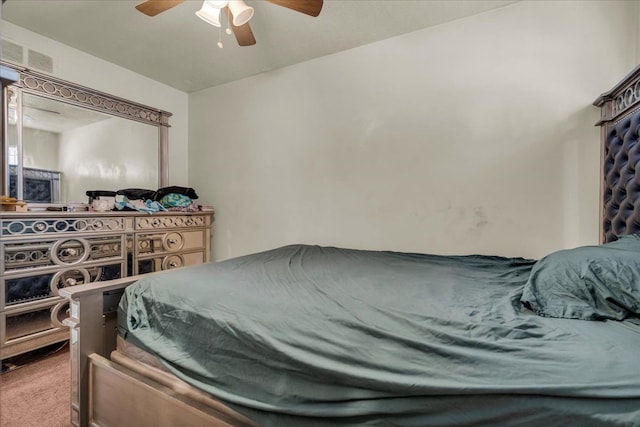 carpeted bedroom with visible vents and ceiling fan