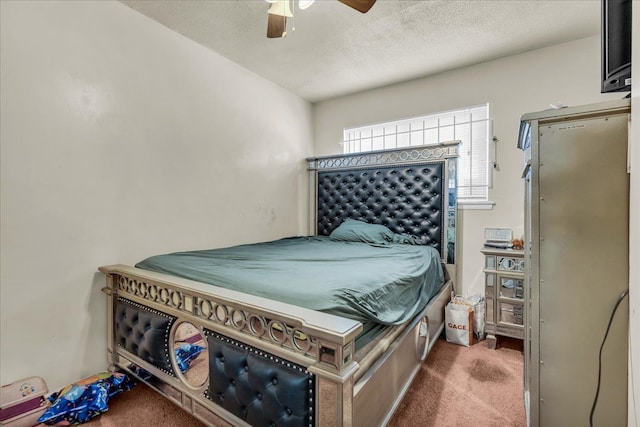 carpeted bedroom with a textured ceiling and a ceiling fan