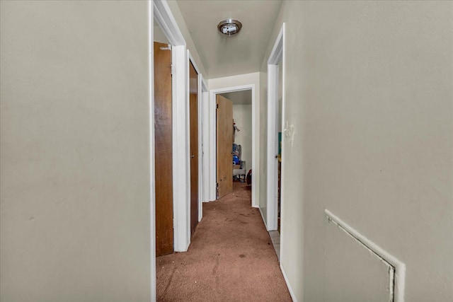 hallway with light colored carpet