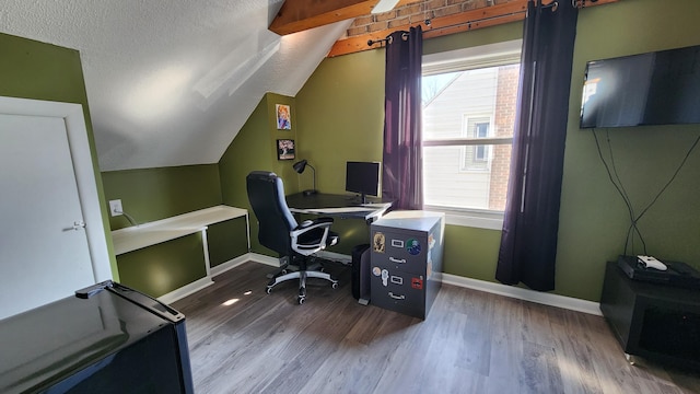 office space with lofted ceiling, wood finished floors, baseboards, and a textured ceiling