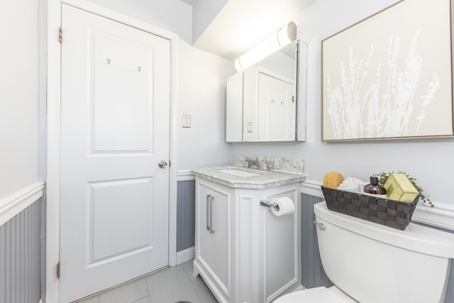 half bathroom with vanity and toilet