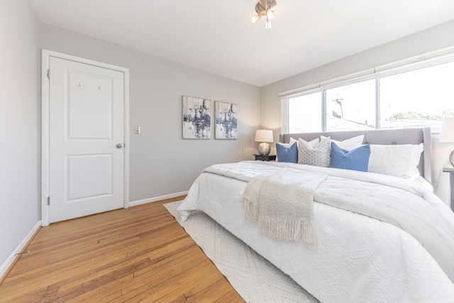 bedroom featuring baseboards and light wood-style flooring