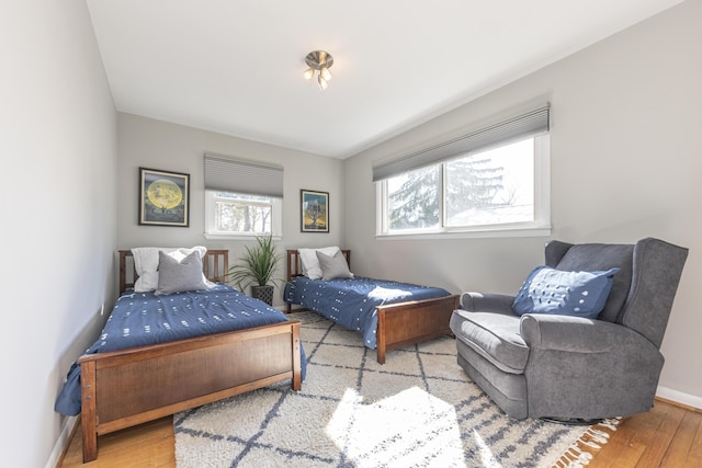 bedroom with baseboards and wood finished floors