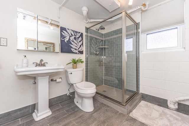 full bathroom featuring a stall shower, toilet, and wood finish floors