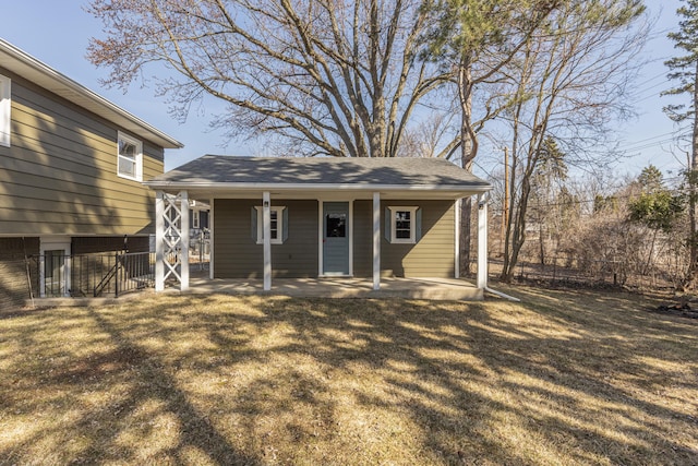 back of property featuring a yard and fence