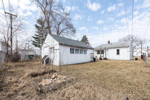 rear view of house with a lawn