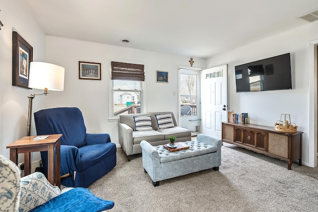 carpeted living area featuring visible vents