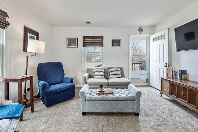 living area with visible vents and carpet