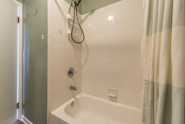 bathroom with shower / bath combo with shower curtain