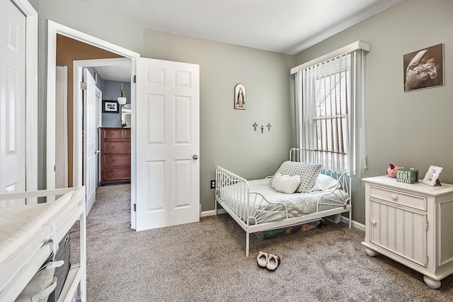 carpeted bedroom featuring baseboards