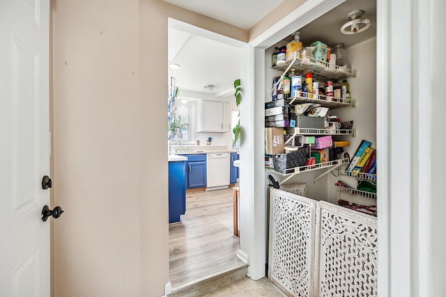 laundry area featuring light wood-style flooring