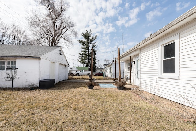 view of yard with an outbuilding and a garage