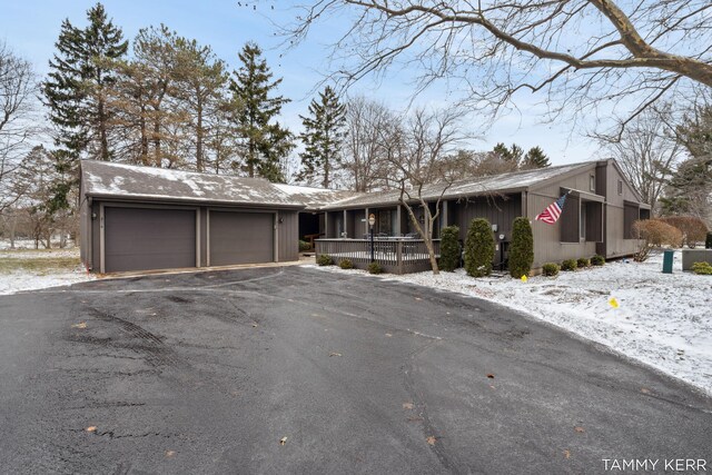 view of front of home featuring a garage and aphalt driveway