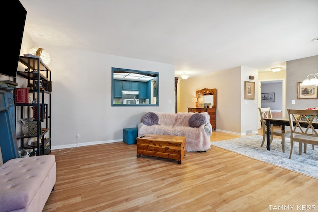 living room featuring baseboards and wood finished floors