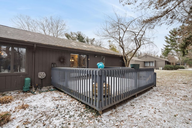 back of house with a shingled roof and a wooden deck