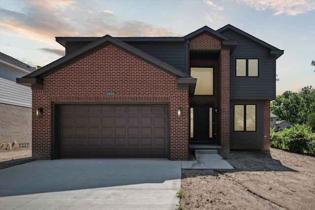 view of front of property featuring concrete driveway, brick siding, and a garage