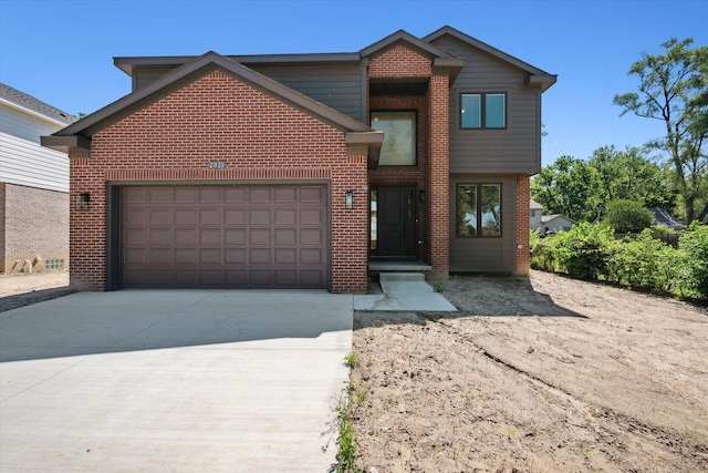 view of front facade featuring brick siding, an attached garage, and concrete driveway