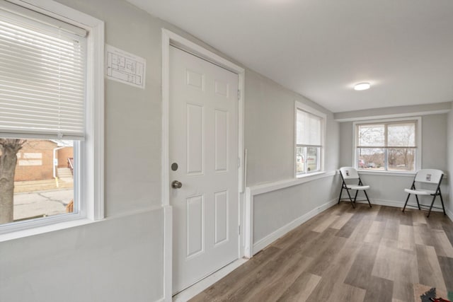 interior space with baseboards and wood finished floors