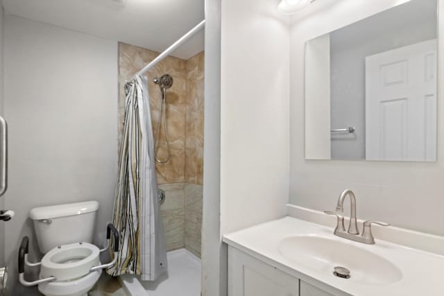 bathroom with vanity, a shower stall, and toilet