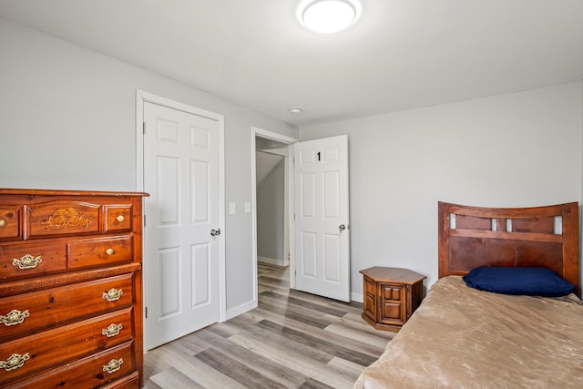 bedroom featuring light wood-style flooring and baseboards