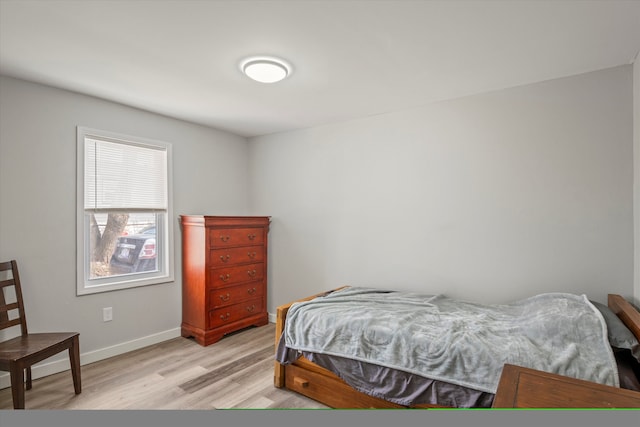 bedroom featuring baseboards and light wood-style floors