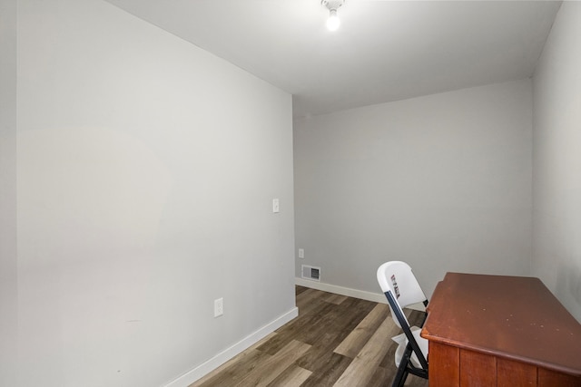 office area with visible vents, baseboards, and wood finished floors