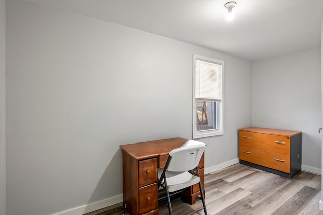 home office featuring light wood-type flooring and baseboards