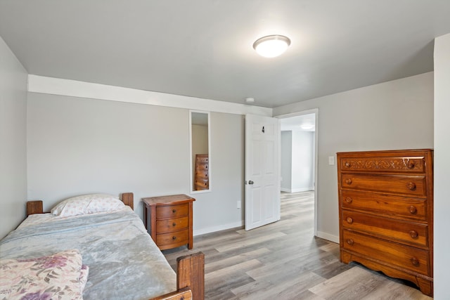 bedroom featuring baseboards and light wood-style flooring