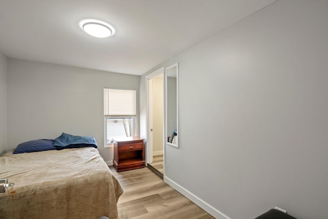 bedroom featuring light wood-type flooring and baseboards