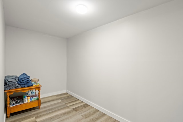 empty room with baseboards and light wood finished floors