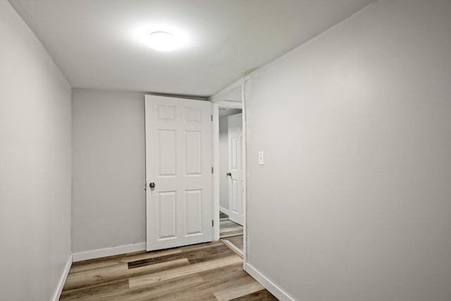 empty room featuring baseboards and wood finished floors