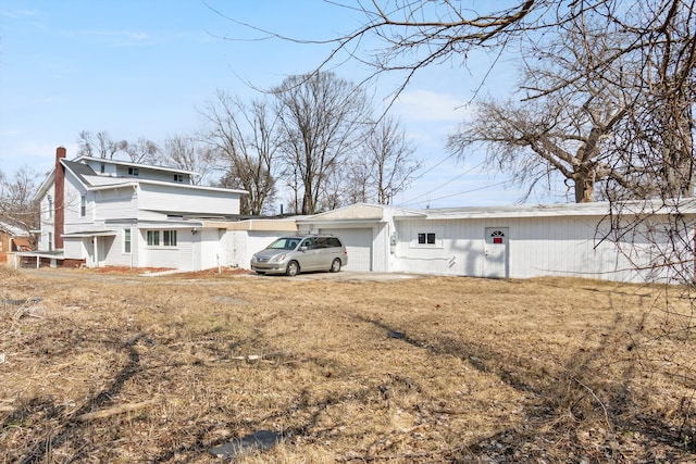 back of property with a garage