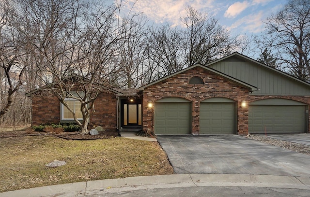 ranch-style house with concrete driveway, brick siding, and a garage