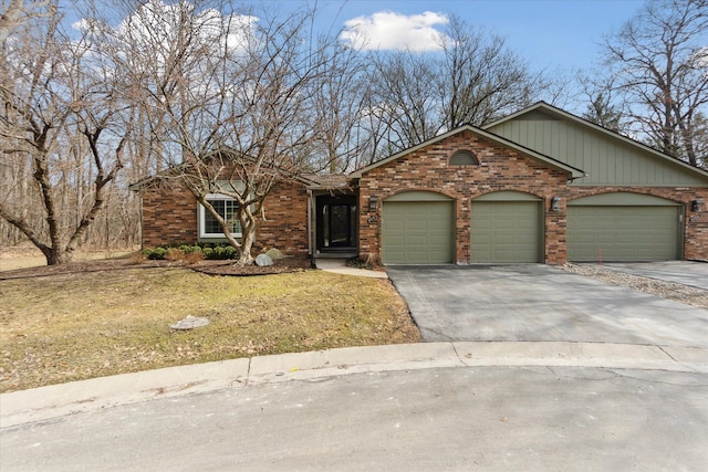 view of front of property with aphalt driveway, a front yard, brick siding, and an attached garage